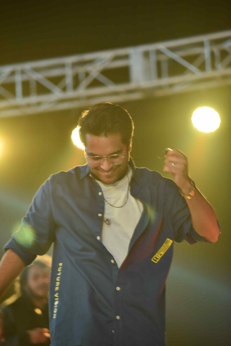Singer under gold stage lights at Circle Club